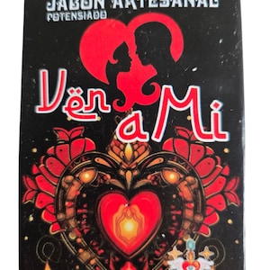 May include: A black and red soap bar with the words "Jabón Artesanal Potenciado" and "Ven a Mi" in white lettering. The soap features a heart design with a couple inside and the words "Agua Divina" at the bottom.