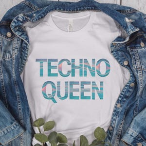May include: White t-shirt with the text "Techno Queen" in blue and pink with a glitchy effect.
