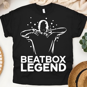 May include: Black t-shirt with a white silhouette of a person beatboxing and the text "Beatbox Legend".