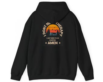 May include: Black hooded sweatshirt with a graphic print of a sunset scene with a tent and trees. The text reads "I don't need therapy I just need to go camping *AMEN*"