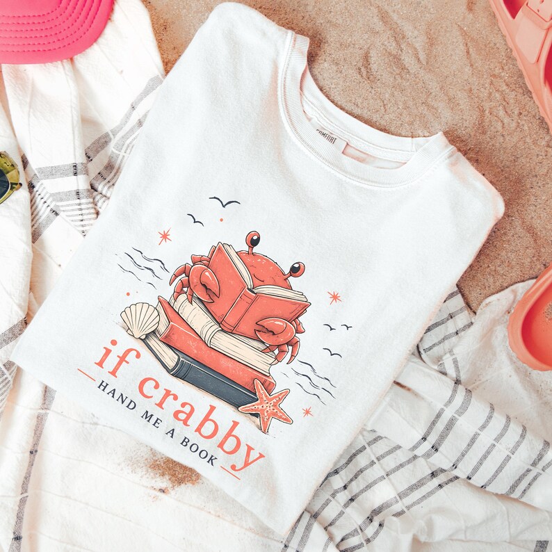 Trendy summer reading shirt for women featuring coastal crab and stacked book artwork