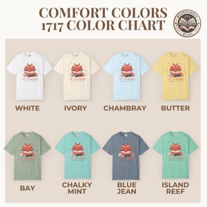 May include: A color chart of eight short-sleeve t-shirts in various colors, including white, ivory, chambray, and butter. Each shirt features a graphic of a crab on a stack of books with the text "if crabby". The text "COMFORT COLORS 1717 COLOR CHART" is at the top.