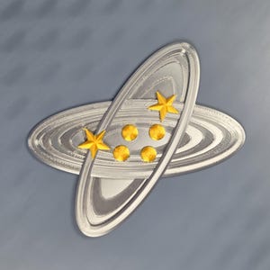 May include: A silver-colored, layered, oval-shaped design with gold stars and circles. The design is set against a gray background. The stars and circles are evenly spaced on the oval.