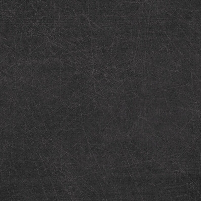May include: A dark gray textured background with a subtle pattern of fine lines.