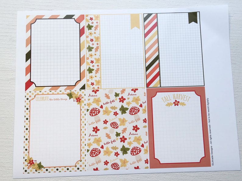 May include: A printed sheet with six rectangular designs, each with a grid pattern. The designs feature autumn-themed borders with fall colors, leaves, and the phrases "Celebrate the little things" and "Fall Harvest."