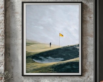 May include: A framed art print depicting a golf course scene. A lone golfer stands near a sand trap, with a yellow flag marking the green. The artwork features a muted color palette of greens, blues, and grays, creating a serene atmosphere.