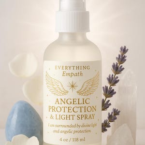 May include: A frosted glass spray bottle labeled "ANGELIC PROTECTION & LIGHT SPRAY" with gold accents. The bottle is 4 oz / 118 ml. The image includes a blue stone, white petals, a sprig of lavender, and a clear crystal.