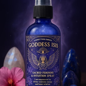 May include: A dark blue Goddess Isis Sacred Feminine & Intuition Spray bottle with a black spray top. The label features gold text and an illustration of a woman with wings. The bottle is surrounded by crystals and a pink flower.
