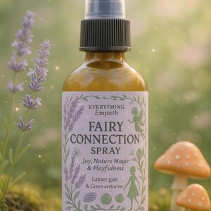 May include: A glass bottle of "Fairy Connection Spray" with a white label featuring text and illustrations. The bottle is amber-colored with a black cap and a clear spray nozzle. The label includes the text "Joy, Nature Magic & Playfulness" and "4 oz".
