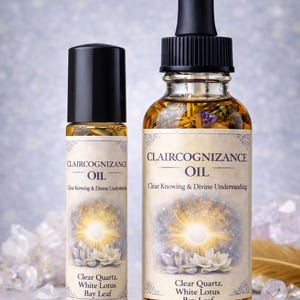 May include: Two glass bottles of Claircognizance Oil with black caps and labels. The labels feature the text "Claircognizance Oil" and "Clear Knowing & Divine Understanding". The bottles contain a golden liquid with floral elements.