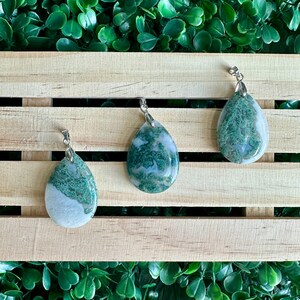 May include: Three green and white agate stone pendants with silver bail. The pendants are teardrop shaped and have a natural, organic look.