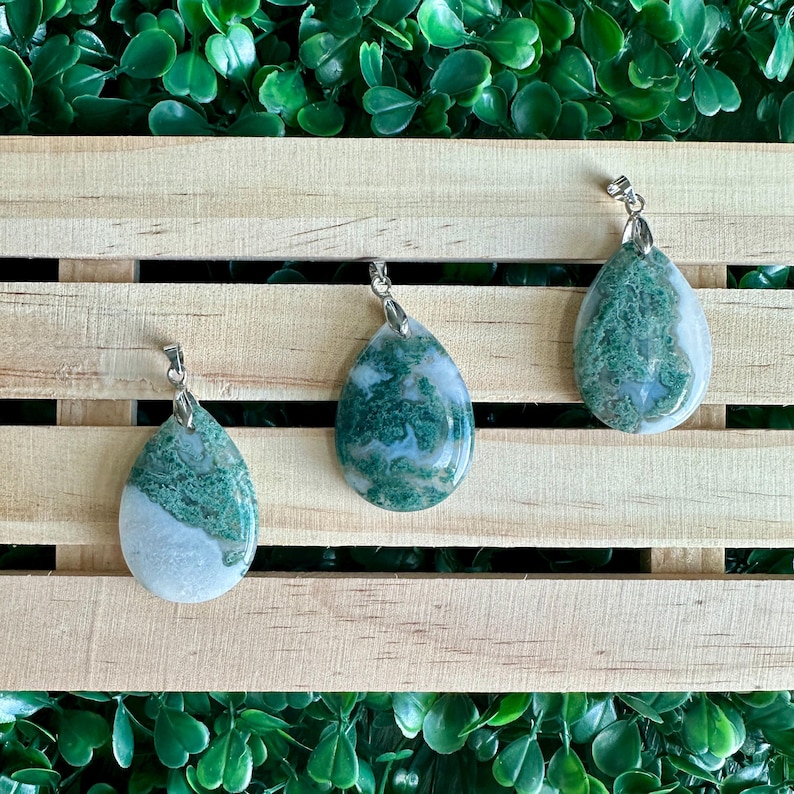 May include: Three green and white agate stone pendants with silver bail. The pendants are teardrop shaped and have a natural, organic look.