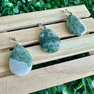 May include: Three green and white agate stone pendants with silver bail loops. The stones are teardrop shaped and have a natural, organic pattern.