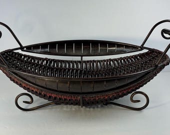 Mediterranean style woven dark wicker basket in iron frame, feet and handles great for serving or decoration.
