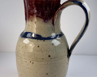 Vintage Art Pottery Pitcher cranberry, and beige with navy stripe  9 1/4” tall