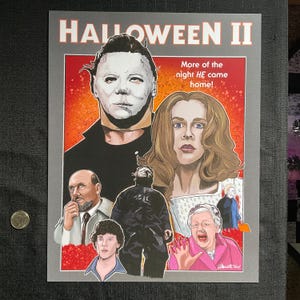 May include: A poster for the horror film Halloween II. The poster features a red and orange background with the title "Halloween II" in white text. The poster also features a portrait of Michael Myers, the film's antagonist, in a black jumpsuit. The text "More of the night HE came home!" is also featured on the poster.
