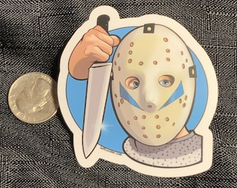 May include: A sticker featuring a cartoon illustration of a person wearing a white hockey mask with blue accents and holding a silver knife. The background is a blue circle with a white outline.