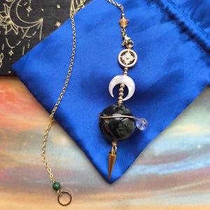 Kambaba Jasper pendulum and its crystal satellite