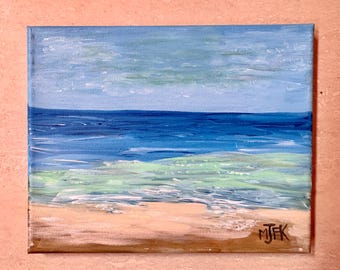May include: Acrylic painting of a beach scene with a blue ocean, light blue sky, and tan sand. The ocean has shades of blue and green. The artist's initials, "MJFK", are in the bottom right corner.