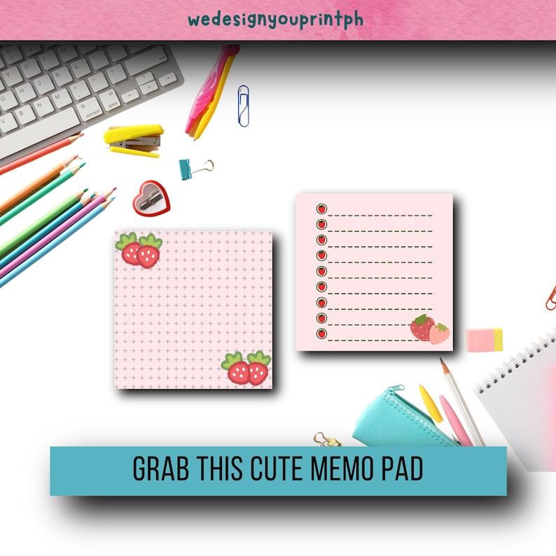 May include: A pink memo pad with a grid pattern and strawberry illustrations. The memo pad has a pink background with a white grid pattern and a strawberry illustration in the bottom right corner. The memo pad is surrounded by various school supplies, including pencils, a stapler, and a pencil case.