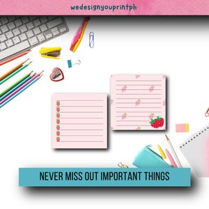 May include: Two pink notepads with lined paper and strawberry illustrations. The notepad on the left has strawberries down the side. The notepad on the right has strawberries scattered across the page. The text "NEVER MISS OUT IMPORTANT THINGS" is at the bottom of the image.