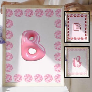 May include: Two pink frames with a pink, 3D letter 'B' in the center of the larger frame. The frames are decorated with a pink and white polka dot border. The smaller frame has a pink and white polka dot border and the letter 'B' in the center.