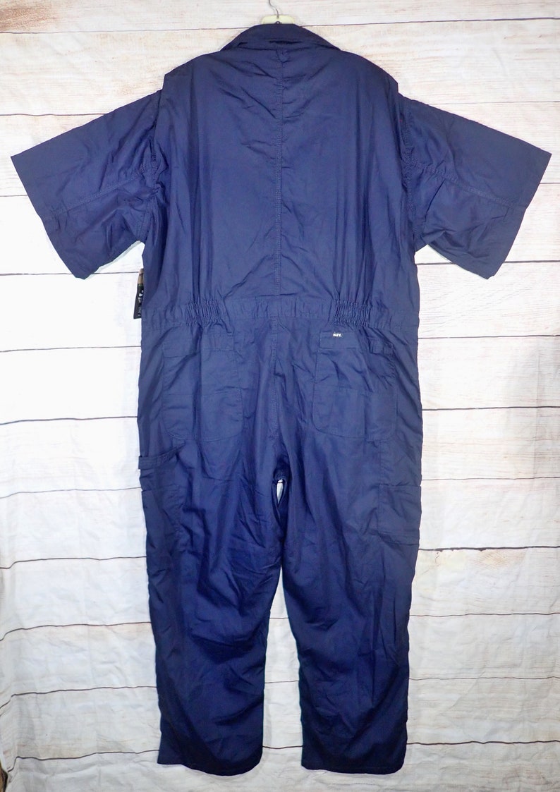 May include: A navy blue short-sleeved jumpsuit with a zipper closure and pockets. The jumpsuit has a drawstring at the waist.