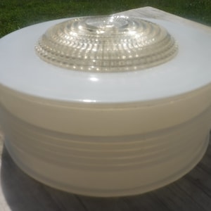 May include: White frosted glass ceiling light fixture with a clear glass dome diffuser. The diffuser has a ribbed pattern.