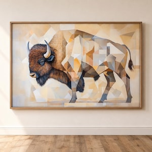 May include: A framed wall art print featuring a geometric, low-poly style illustration of a bison. The artwork uses a warm color palette of tan, beige, brown, and cream tones, depicting the animal with sharp, angular shapes and facets.