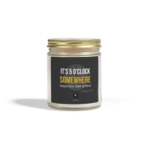 May include: A glass jar candle with a gold lid and a black label. The label reads "IT'S 5 O'CLOCK SOMEWHERE" in white and gold lettering. Below the text is "Happy Hour State of Mind" and a small graphic.