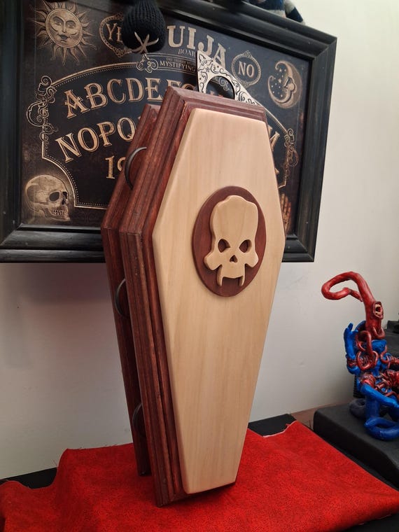A handcrafted solid-wood coffin jewelry box with a demonic skull lid — genuinely macabre, one-of-a-kind craft that doubles as functional oddity cabinet.