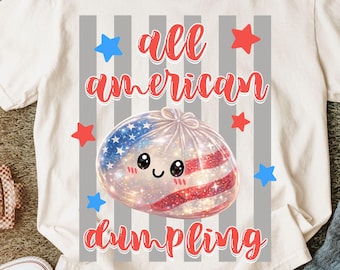 May include: White t-shirt with the text "all american dumpling" in red script. The graphic features a dumpling with an American flag design, surrounded by red and blue stars. The shirt is on a green surface.