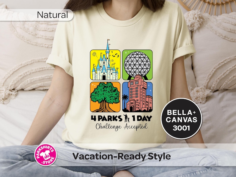 Puede incluir: Camiseta color crema con un gr&aacute;fico colorido que presenta cuatro cuadrados con im&aacute;genes ic&oacute;nicas de parques tem&aacute;ticos. El texto "4 PARKS 1 DAY Challenge Accepted" est&aacute; debajo de los cuadrados. La camiseta tambi&eacute;n tiene el texto "BELLA+ CANVAS 3001".