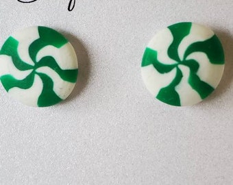 May include: A pair of round, white and green swirl earrings. The earrings are on a white background with the text "Starfall at Dusk" in cursive script. The earrings are nickel free jewelry.