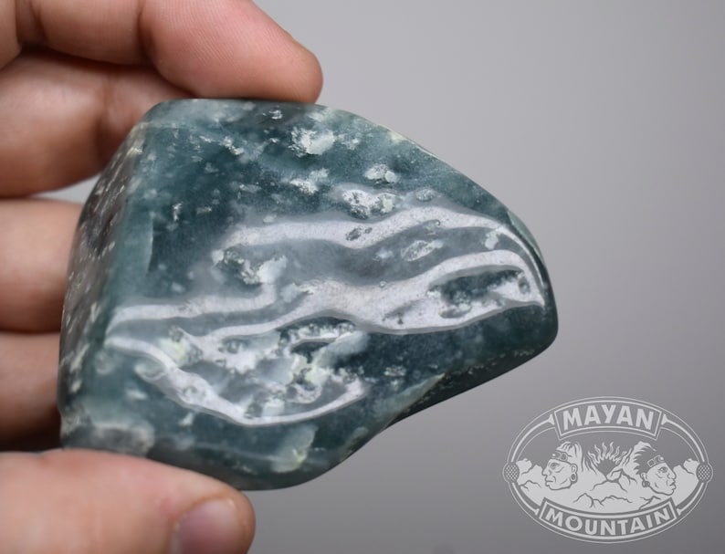 May include: A smooth, light blue and white agate stone with a swirling pattern. The stone is polished and has a translucent appearance.
