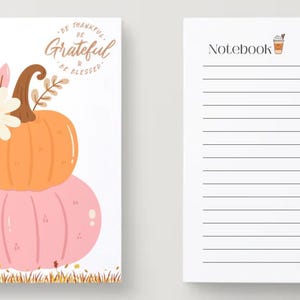 May include: Spiral-bound notebook with a fall theme. The cover features a stacked orange and pink pumpkin design with floral accents and the words "Be Thankful, Be Grateful, Be Blessed." The interior pages are lined.