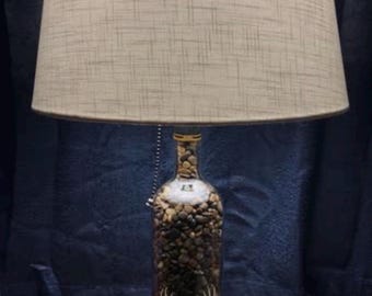 Custom made Bourbon George T Stagg bottle lamp with shiny pebbles. Shade and base not included.