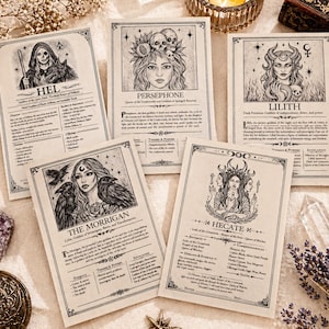 May include: Five vintage-style cards featuring illustrations of goddesses, including Hel, Persephone, Lilith, The Morrigan, and Hecate. Each card has a detailed drawing of the goddess and accompanying text. The cards are arranged on a light-colored surface with decorative elements.