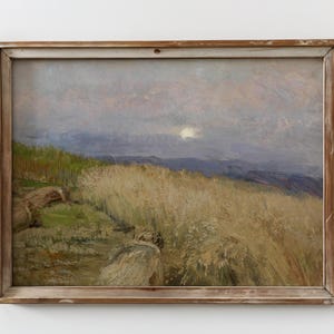 May include: An antique landscape painting in a wooden frame. The artwork depicts a field of tall, golden grass under a cloudy sky with a bright sun. The painting has a vintage aesthetic, with muted colors and visible brushstrokes.