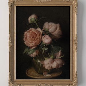 May include: A framed floral still life painting. The artwork features a bouquet of pink peonies in a glass vase, set against a dark background. The ornate gold frame adds a vintage aesthetic to the piece.