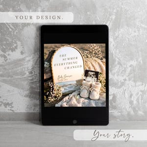 May include: A digital tablet displaying an arched mirror with the text THE SUMMER EVERYTHING CHANGED, Baby Swanson, and FEBRUARY 2027. Beside the mirror are a baby sonogram, a pair of small cream-colored knit booties, and white floral accents.