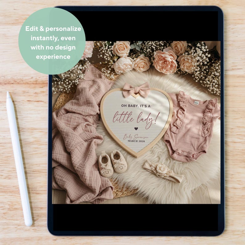 May include: A heart-shaped announcement board with the text "OH BABY, IT'S A little lady!" and baby items. The scene includes a pink onesie, shoes, a headband, and a blanket, all arranged on a fluffy white surface with floral accents.