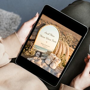 May include: A digital tablet displaying a pregnancy announcement graphic featuring an arched mirror with the text And Then There Were Five, Baby Swanson, and November 2026, alongside a sonogram, cream-colored baby booties, and white flowers.