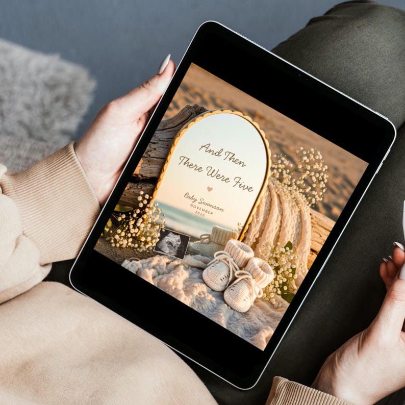 May include: A digital tablet displaying a pregnancy announcement graphic featuring an arched mirror with the text And Then There Were Five, Baby Swanson, and November 2026, alongside a sonogram, cream-colored baby booties, and white flowers.