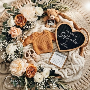 May include: A baby announcement with a teddy bear, ultrasound photo, and a small mustard-colored sweater. A heart-shaped chalkboard reads "See you in September, Baby Swanson." The scene includes baby shoes, a calendar, and floral arrangements.