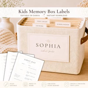 May include: A beige fabric memory box labeled "Kids Memory Box Labels" with the name "Sophia" and "School Years". The box contains file folders labeled "First Grade", "Artwork", and "School Photos". Includes printable memory pages.