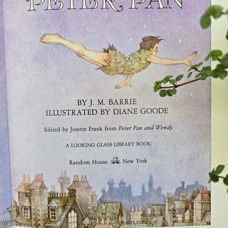 May include: A vintage hardcover book titled "Peter Pan" with an illustration of Peter Pan in flight. The cover features text by J.M. Barrie and illustrations by Diane Goode. Published by Random House, New York.