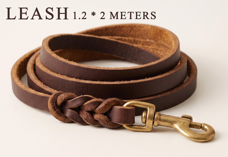 May include: A dark brown leather leash coiled in a circle, featuring a braided section near a brass swivel snap hook. The text LEASH 1.2 * 2 METERS is printed above the leash, indicating the dimensions of the leather strap in meters.