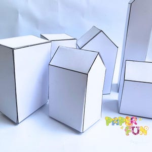 May include: A collection of white paper structures with black outlines, including rectangular prisms and house-shaped forms with peaked roofs. The text PAPER FUN is printed in colorful, decorative letters in the bottom right corner of the image.