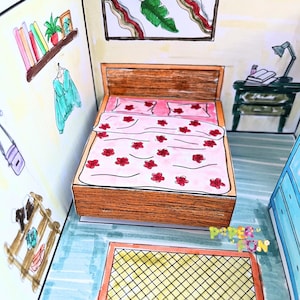 May include: A papercraft bedroom scene with a wooden bed, pink bedding, and red flower details. A small green bedside table with a lamp and books is next to the bed. The room includes a shelf with books and a plant, and a rug.
